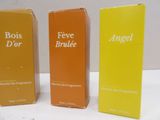 three boxes of perfume sitting on top of a white table