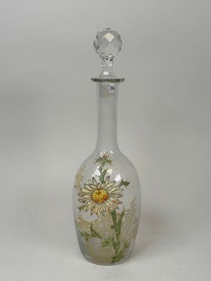 a glass bottle with a flower painted on it