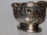 a silver bowl that is sitting on a glass table