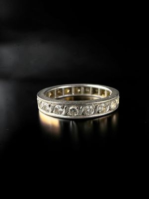 a close up of a wedding ring on a black surface