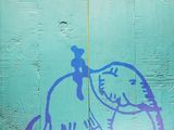 painting of a man riding an elephant on a blue wall