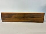 a close up of a piece of wood on a white surface