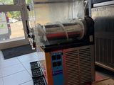 a machine that is sitting on the floor next to a box