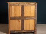 an old wooden cabinet with four doors and a wooden top