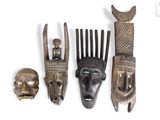 several pieces of african art are displayed on a white surface