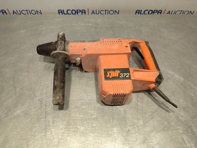 a close up of an electric drill on a metal surface