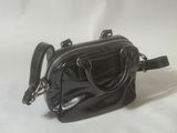 a small black purse on a white background