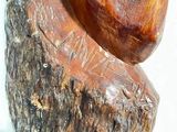 a wooden sculpture of a heart on a tree stump