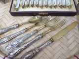 a tray with silverware on a table with a tray of forks and spoons