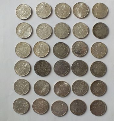 a close up of a bunch of coins on a white surface