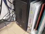 a computer tower that has a bunch of books on top of it