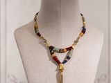 beaded necklace with a tassel on a mannequin neck
