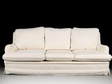 a white couch that is sitting in the dark