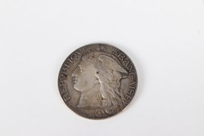 a silver coin with a woman ' s face on it