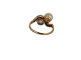 a close up of a gold ring with a pearl on it