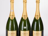 three bottles of champagne sitting next to each other on a table