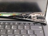 a laptop that has a broken screen and is sitting on a table