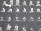 a lot of glass chess pieces on display in a glass case