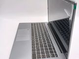 a silver laptop with a black keyboard on a white surface