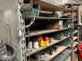 a man that is standing next to a shelf with tools