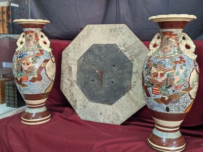 three vases sitting next to each other on a red cloth