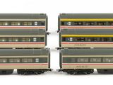 several toy trains are lined up in a row on a white surface