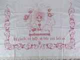 an embroidered table cloth with a picture of a cake on it