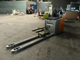 a forklift that is sitting in the middle of a warehouse