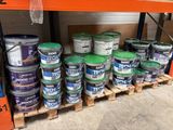 a bunch of buckets of paint on a pallet in a store