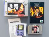three games and a gameboy sitting on a table