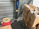 a scale that is next to some boxes and a roll of toilet paper