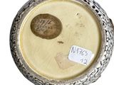 a picture of a silver vase with a label on it