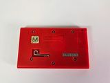 an old red nintendo game console sitting on top of a white table