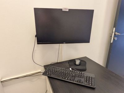 un écran d'ordinateur et un clavier sur un bureau dans une pièce