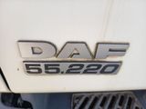 a close up of the daf logo on the front of a white truck