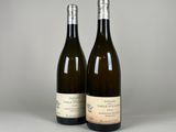 two bottles of wine sitting next to each other on a table