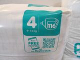 a bag of diapers sitting on the floor next to a bag of toilet paper