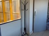 a room with a door, a window, and a tripod in it