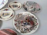 many plates with different designs on them on a table