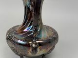 a silver vase that is sitting on a table