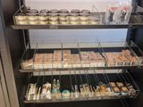 many trays of food on the shelves in the store