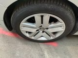 a close up of a car ' s tire on the pavement