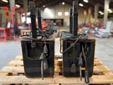 two radio ' s sitting on a pallet in a warehouse