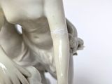a statue of a man with a goat on a table