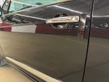 a close up of a car door handle with a sticker on it