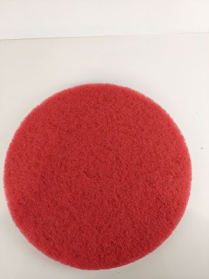 the red sponge is sitting on top of a white surface