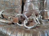 a close up of a purse with a key on it