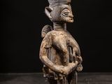 a statue of a man holding a baby in his arms