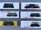 six different model trains are in a box on a table
