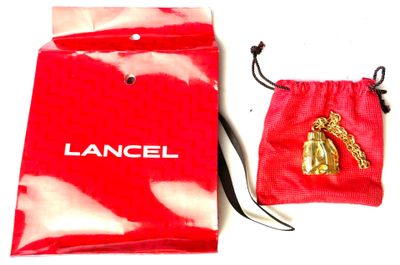 a red bag with a pair of gold shoes on it